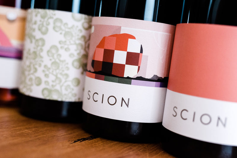 Close-up of colourful labels on wine bottles 